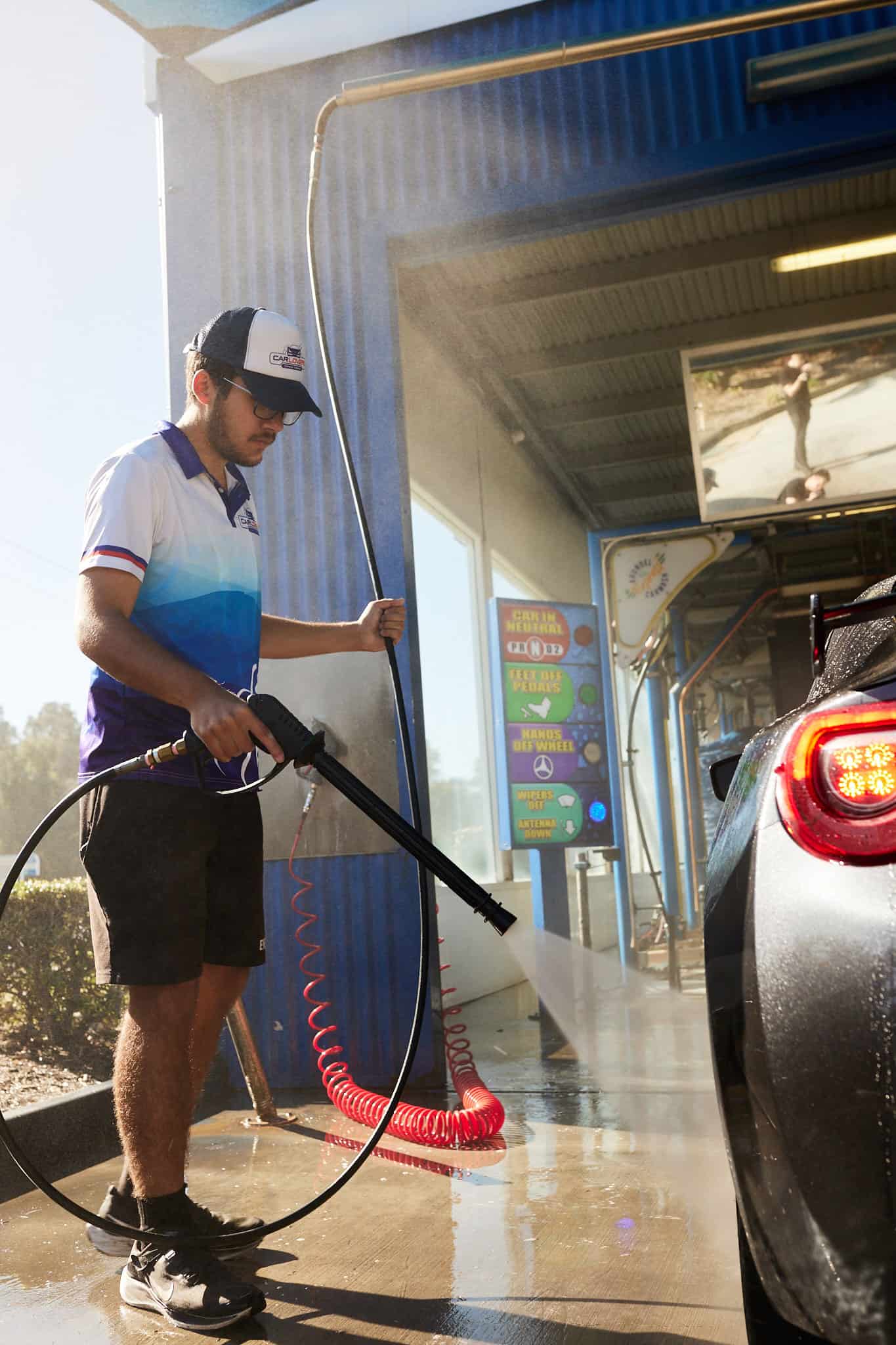 A Car Lovers Express employee while cleaning a vehicle